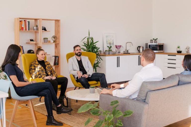 people sitting in a room having an interview with the employers Feature Image For: The "New Normal" Recruitment Strategy