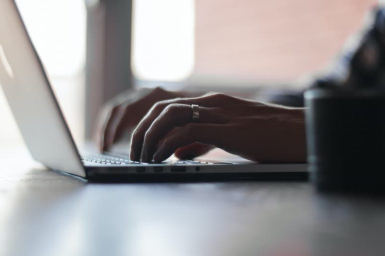 un hombre en su computadora portátil escribiendo Imagen destacada para: 15 mejores portales de empleo para publicar trabajos a tiempo parcial