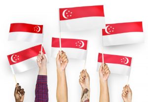 hands waving Singapore flag