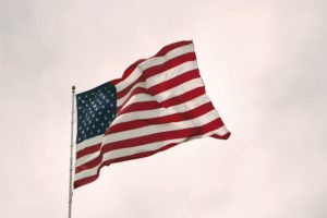 Flag of the United States of America against a cloudy sky. Feature image for "Top 20 Highest Paying Jobs in the United States"
