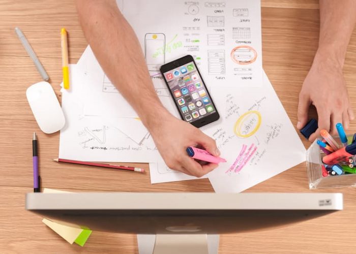 a person taking notes from his computer on the desk Feature image for Top 10 Transferable Skills Employees Need To Succeed