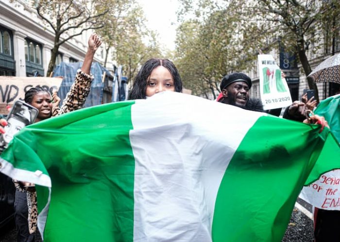 a women holding Nigerian flag feature Image For: Top 30 High-Paying Careers for Women in Nigeria (with Salary)