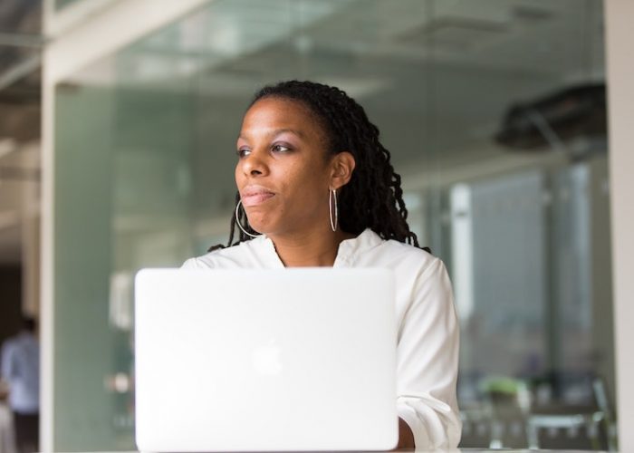 Closeup of a woman looking to the right while using her laptop. Feature image for "The Importance of Highlighting Your Skills for Potential Employers"